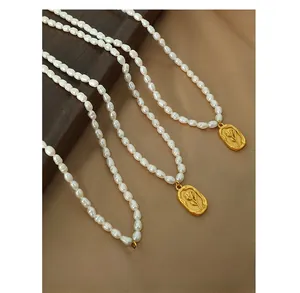 Detail of freshwater pearl necklace featuring a vintage gold rose relief pendant