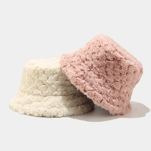 Minimalist winter plush bucket hats in cream white and soft pink with fluffy textures