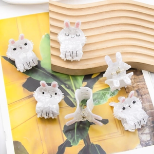 Set of 5 cute white marble bunny hair claws with pink ears on a wooden tray