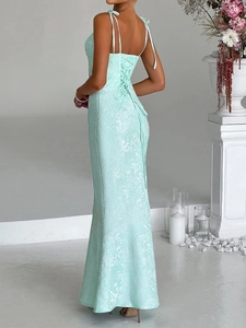 Detail of mint green floral maxi dress featuring elegant back lace-up and thin straps