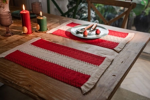 Detailed texture of red and white striped cotton woven placemat with elegant fringe edge