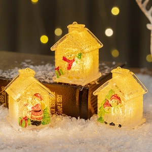 Set of three glowing Christmas house ornaments with festive LED lights and Santa motifs
