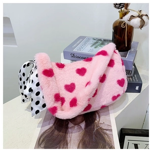 Detailed close-up of pink fluffy heart bag with silk ribbon bow in a lifestyle setting