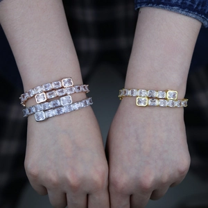 Hip hop style bangles in rose gold and gold plating with emerald cut cubic zirconia