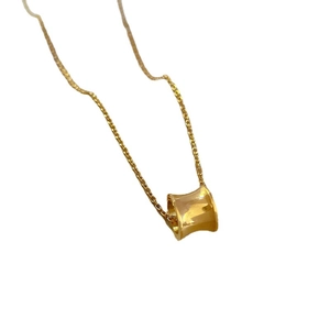 Minimalist gold-plated stainless steel cylinder pendant necklace on a clean white background
