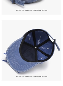 Detail of vintage washed denim baseball cap featuring distressed brim and metal buckle