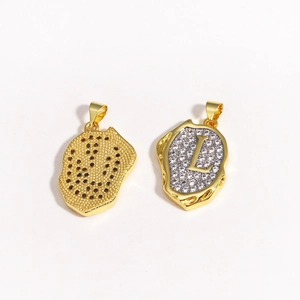 Detail of 18k gold plated letter L pendant with contrasting white and black zircon stones