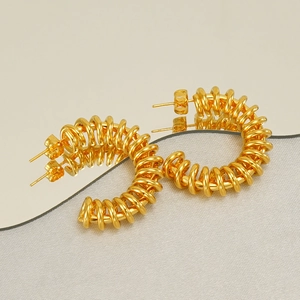 Modern gold C-shape spring earrings with a hollow spiral design in polished stainless steel
