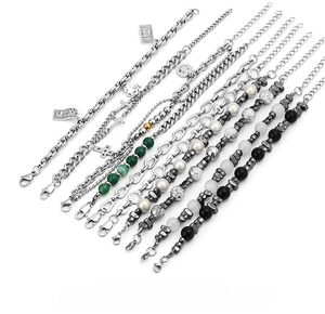 Detailed set of titanium steel bracelets with dark stones, pearls and $100 pendant charms