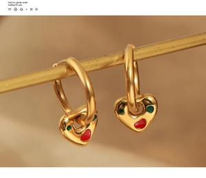 Macro shot of titanium steel heart drop earring with colorful glaze and inlaid zircon