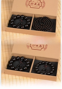 Macro shot of ebony wood beads with calabash pendant in a vintage gift box