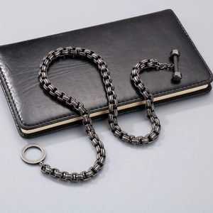 Vintage titanium steel barbell OT buckle chain necklace on black leather notebook