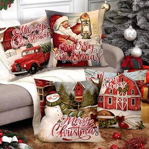 Set of 4 Christmas pillow covers with red truck and snowman prints on sofa