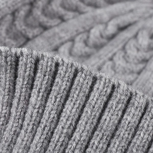 Thick grey cable knit beanie hat with ribbed cuff detailing for autumn and winter