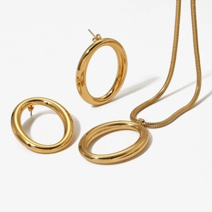 Golden stainless steel jewelry set featuring oval pendant necklace and hoop earrings