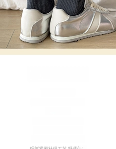 Detail of dark grey knit sock with a delicate bow accent worn with silver sneakers