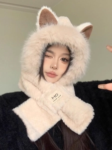 Detailed texture of fluffy apricot faux fur on a winter hooded scarf with fox ears