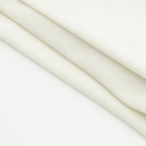 Close-up of premium white knitted fabric texture showing refined weaving and soft material