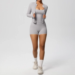 Close-up of grey three-piece yoga set with zip jacket, camisole, and high-waist shorts