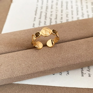 Macro detail of 18k gold plated tiger eye ring featuring two brown beads on a vintage background