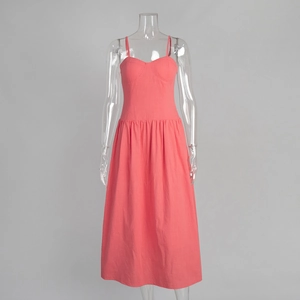 Detailed view of coral pink cotton maxi dress with smocked waist and spaghetti straps