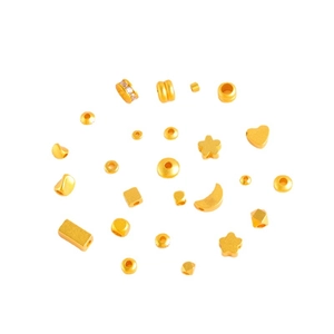 Mix of gold DIY jewelry beads in heart, star and moon shapes on white background