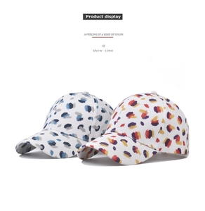 Detail view of cotton baseball caps featuring vibrant abstract paint splatter patterns