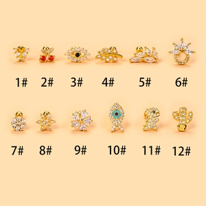 Detail of 12 sets of golden stud earrings with zircon in animal and flower shapes