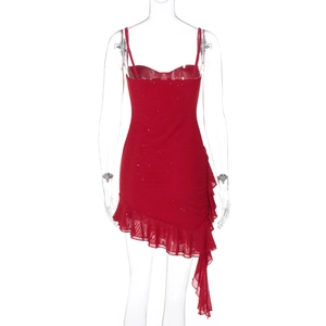 Macro shot of red sequined dress showing sparkling fabric and asymmetric ruffle hem detail