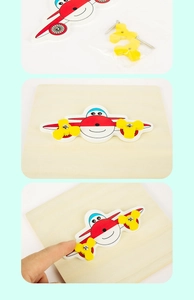Detailed view of DIY red wooden airplane busyboard accessory with propeller parts