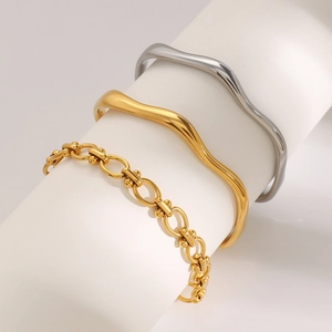 Polished wave-shaped gold and silver open bangles with industrial link bracelet detail