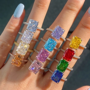 Macro shot of colorful rectangular cut gemstones set in silver and gold diamond rings