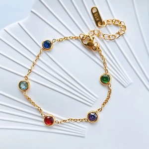 Delicate 18K gold chain bracelet featuring five vibrant round-cut multi-color gemstones
