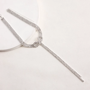 Detail of silver rhinestone Y-necklace featuring parallel double chain fringe tassels