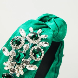Green chiffon knotted headband featuring emerald crystals and luxury rhinestone details