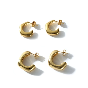 Set of four minimalist 18k gold-plated C-shaped stainless steel earrings on white background