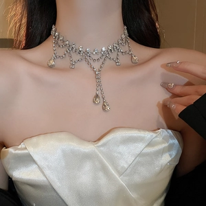 Close-up of elegant silver choker with layered rhinestones and waterdrop tassels