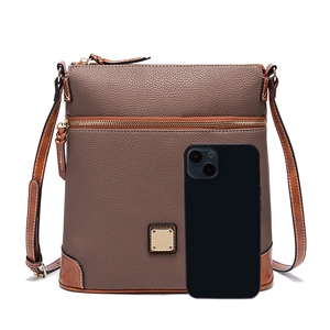 Detail view of taupe pebble leather crossbody bag with smartphone for size reference