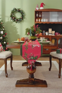 Macro detail of red Christmas table runner with green tassels and festive holiday patterns