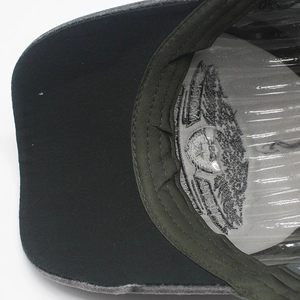 Detail shot of baseball cap interior showing reinforced stitching and logo print