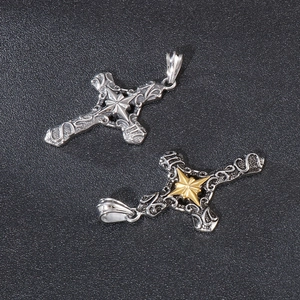 Macro shot of silver and gold vintage gothic cross pendants with intricate relief patterns