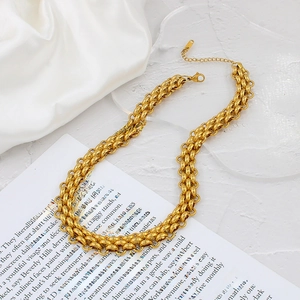 Elegant 18K gold plated titanium steel multi-link choker necklace on silk background