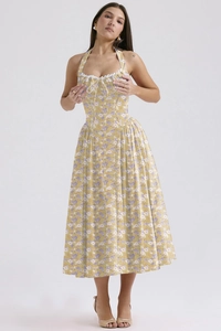 Close-up of yellow floral maxi dress featuring a halter neck and white lace trim detail
