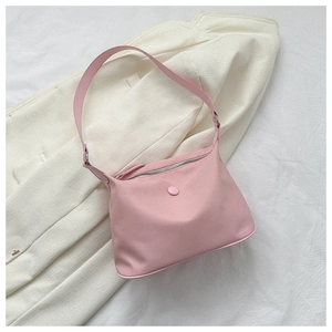 Detail of light pink nylon shoulder bag showing durable texture and silver zipper finish