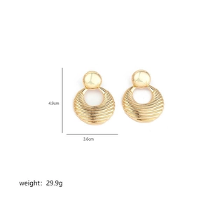 Detail view of gold textured disc earrings showing 4.9cm height and 3.6cm width