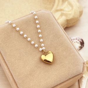 18K gold plated heart pendant necklace with elegant white pearls on a jewelry box