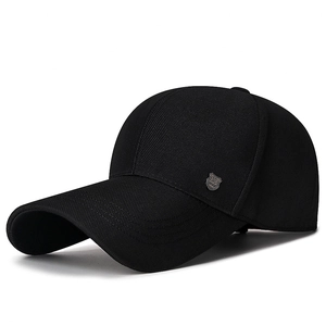 Classic black men's baseball cap with metal logo, side view on white background