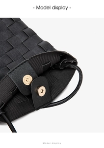 Macro view of woven black bucket bag featuring magnetic closure and drawstring detail