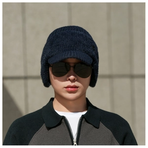 Close-up of men's dark blue knitted earflap hat showing warm vertical ribbed texture
