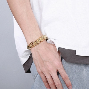Golden dragon bone chain bracelet for men worn on wrist with minimalist casual outfit